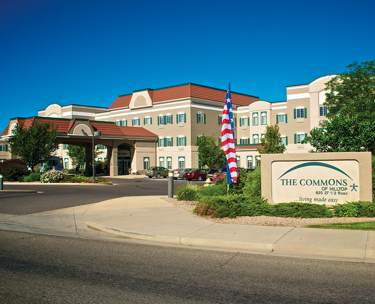The Commons of Hilltop assisted living community building in Grand Junction, Colorado with main entrance and landscaped grounds