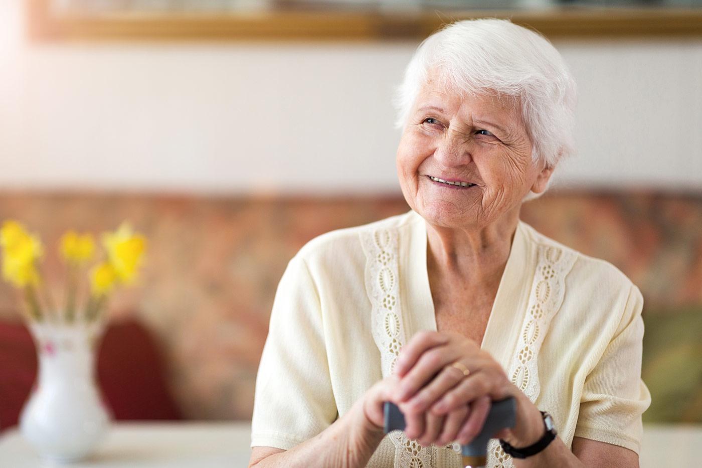 Smiling senior woman enjoying independent living at The Commons in Grand Junction, Colorado, highlighting a maintenance-free lifestyle with no home upkeep, access to dining and activities, and supportive care available as needs change.