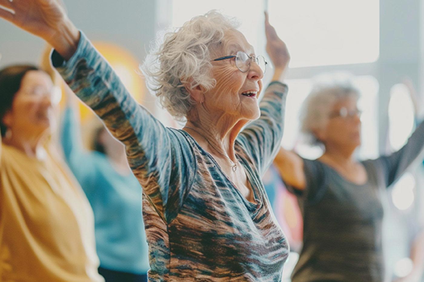 Active senior woman participating in a group fitness class at The Fountains in Grand Junction, Colorado, highlighting wellness programs like yoga, tai chi, and Balance for Life that support healthy, active senior living.